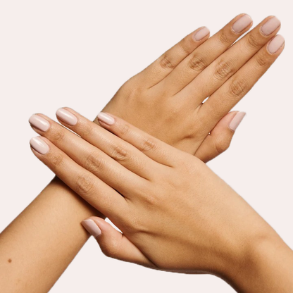 Hands crossed displaying smooth nails polished in CDJ, a cool creamy neutral gel polish perfect for a balanced manicure