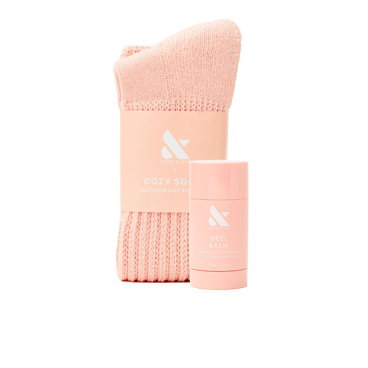 Overnight Heel Repair Set with soft pink knit socks and moisturizing Heel Balm stick on white background