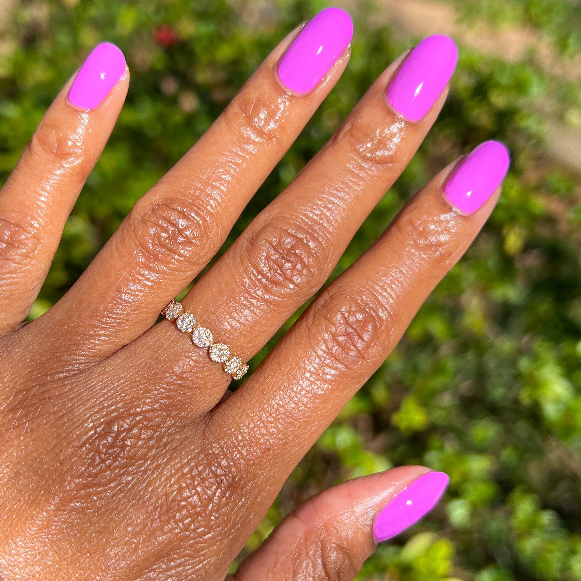 Hand with nails painted in vibrant magenta shade using Jam, Please polish for a bright, long-lasting manicure by Olive and June