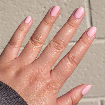 Hand with nails painted in soft bubbly pink shade SE, showing a smooth and fresh at-home manicure look
