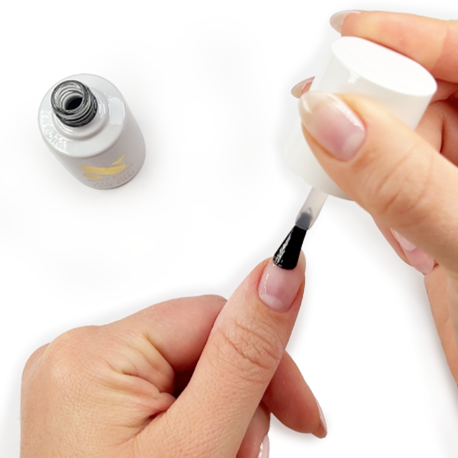 Hand applying Gel Base Coat on natural nail with open bottle and brush in clean bright setting for mani prep