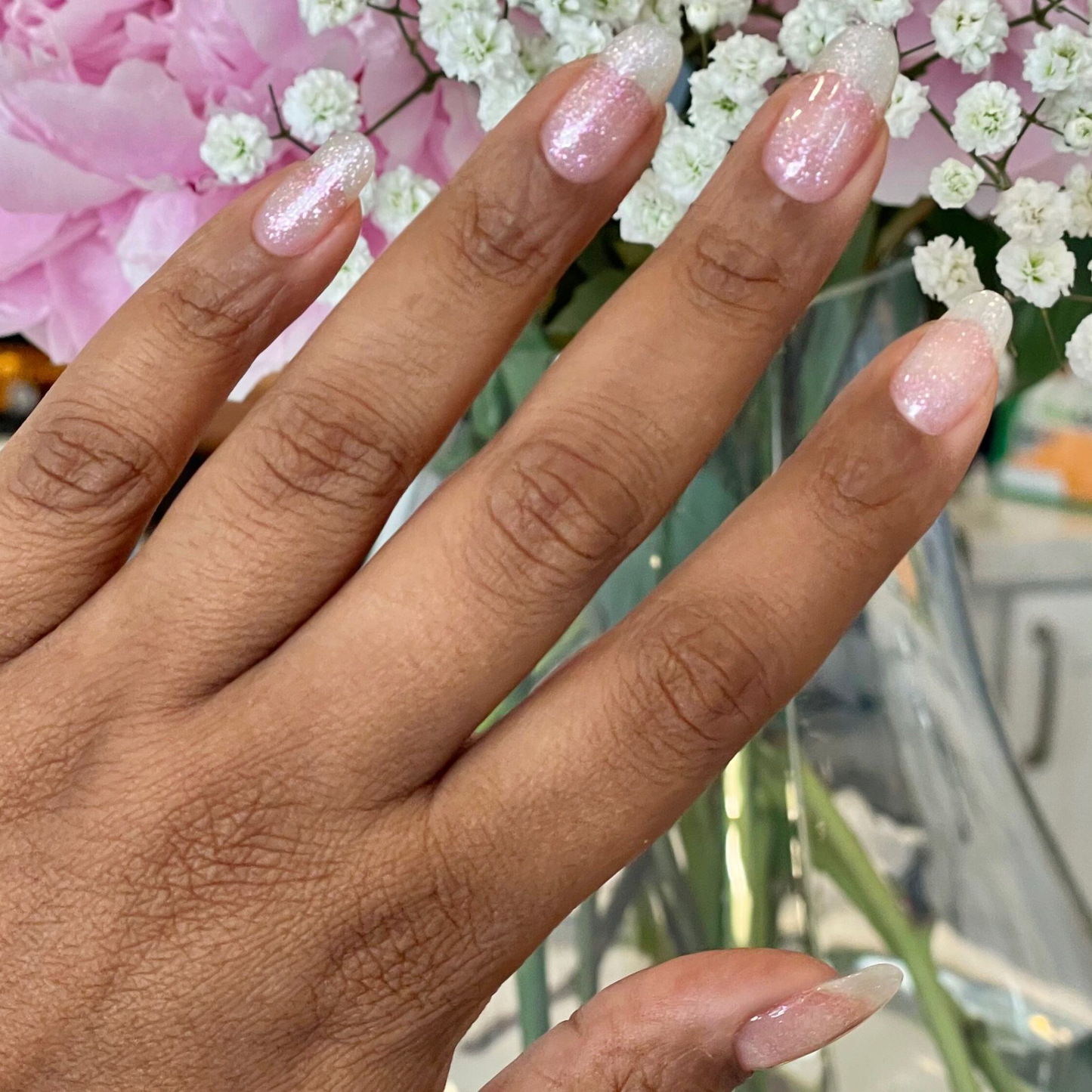 Hand with soft pink nails sparkling with DIAMONDS ARE A MANI’S BEST FRIEND Gel for a radiant manicure look