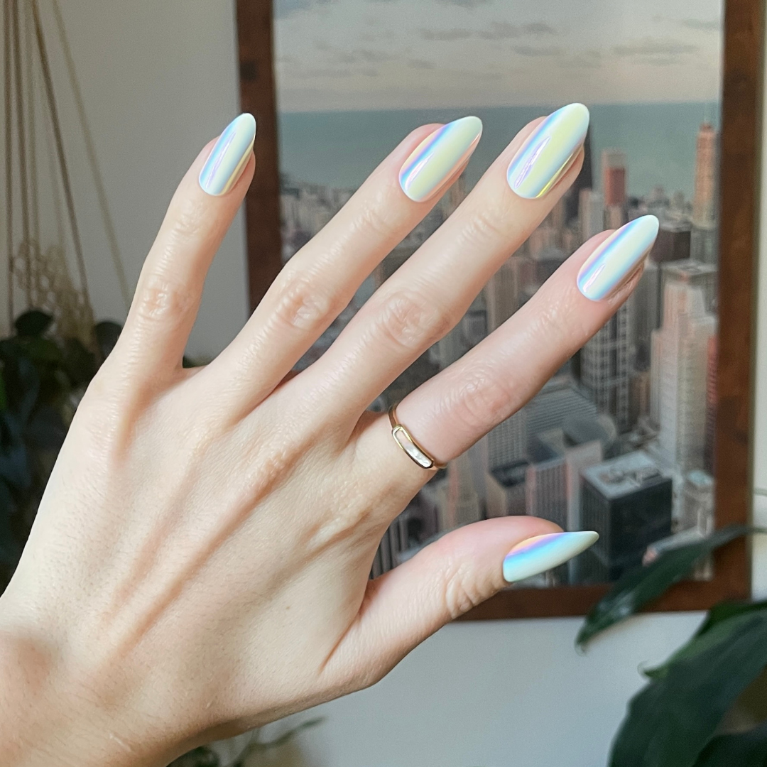 Iridescent Chrome - Press-On | Long | Almond showing hand with shiny white iridescent chrome long almond press-on manicure indoors