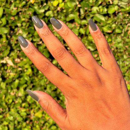 Is It Smoky In Here? Gel polish on long natural nails in deep charcoal gray for an elegant at-home manicure by Olive and June