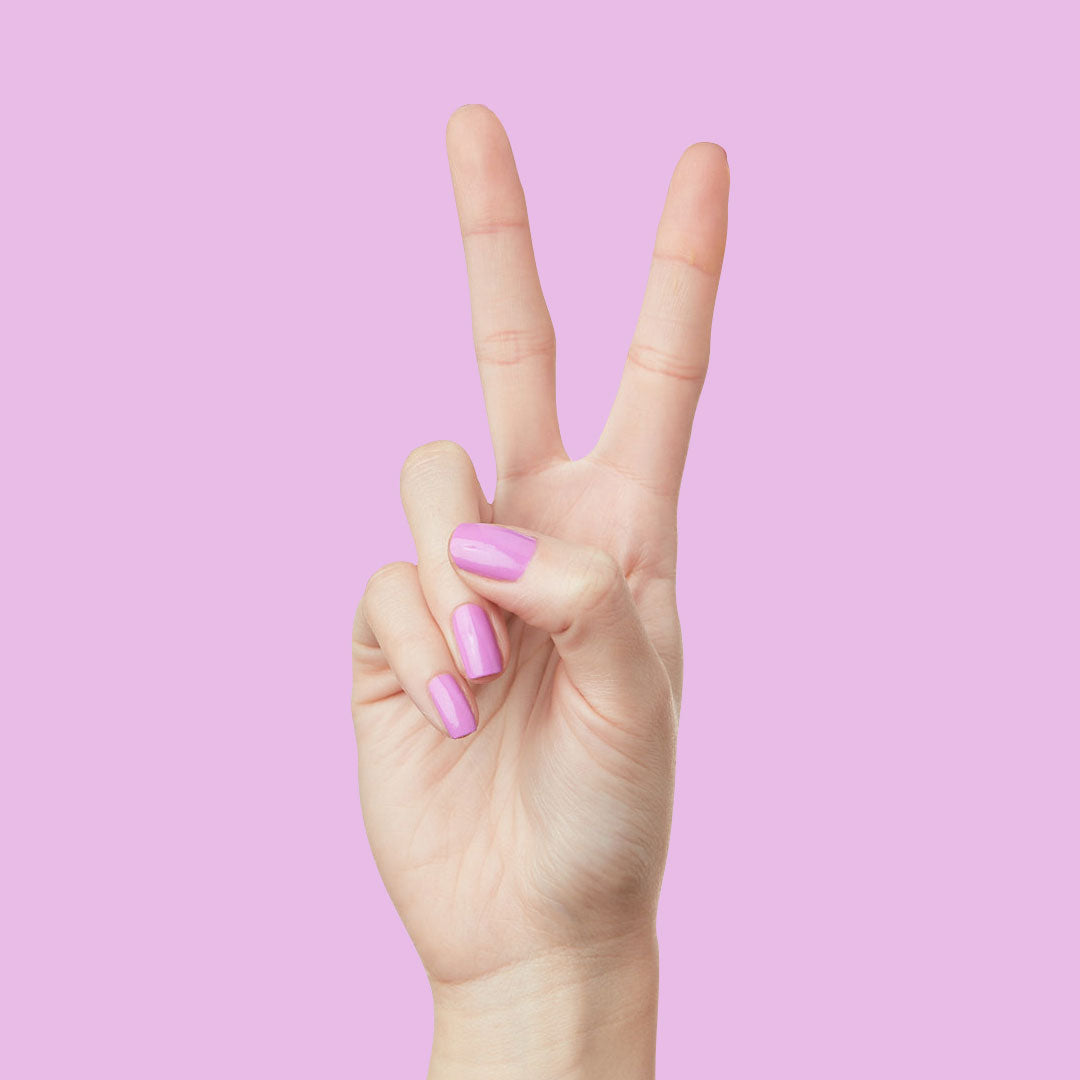Hand showing peace sign with nails painted in glowing soft magenta Jam, Please polish for a shiny manicure