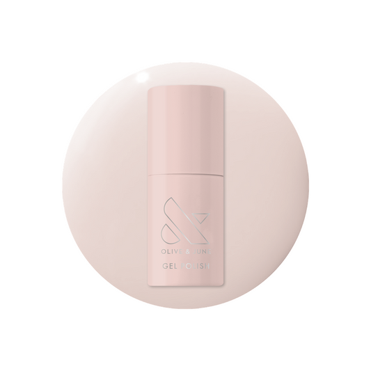 Bottle of Olive and June Dream Job - Gel polish in milky sheer pink with matching color background