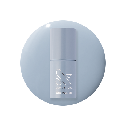 Vintage - Gel polish bottle in a classic denim blue shade on a matching blue gel polish background by Olive and June