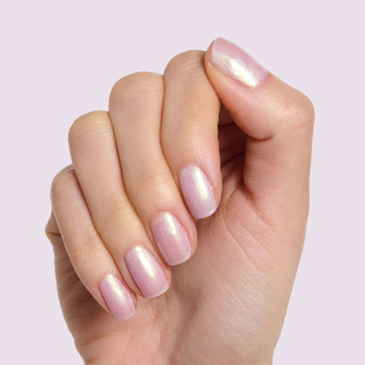 Hand showing a glossy milky lavender mani with iridescent Purple Puka gel polish on natural nails