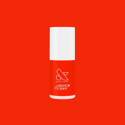 Bottle of Snapdragon bright orange-red quick dry gel polish by Olive and June on solid red background