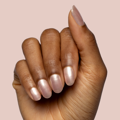 Hand displaying nails painted in sheer shimmery pink Supernova quick dry gel polish manicure