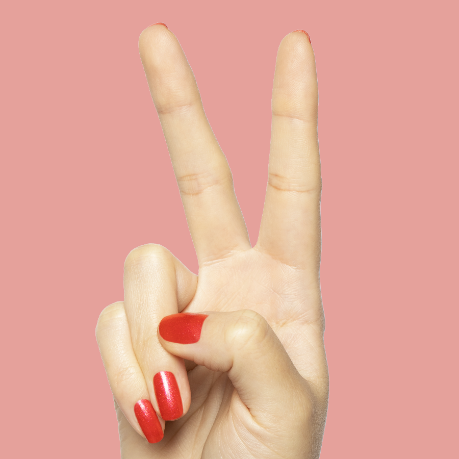 Hand showing peace sign with bright pinky-red Rodeo Queen polish with silver shimmer for a mani