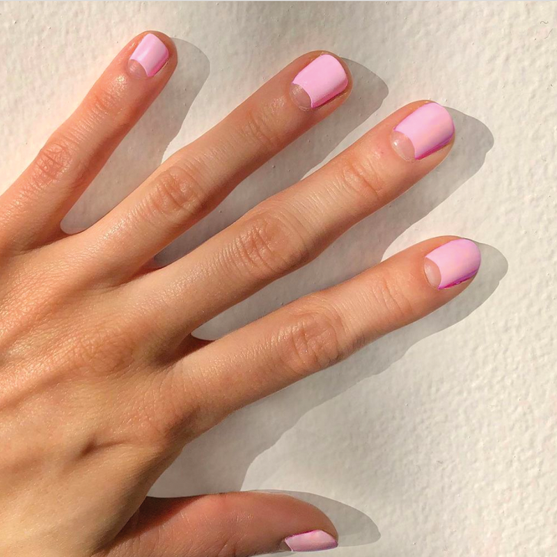 Hand with nails painted in soft bubbly pink SE polish, showcasing a fresh and smooth at-home manicure look