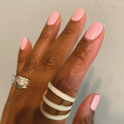 Hand with nails painted in soft bubbly pink SE polish, showcasing a smooth and fresh at-home manicure look